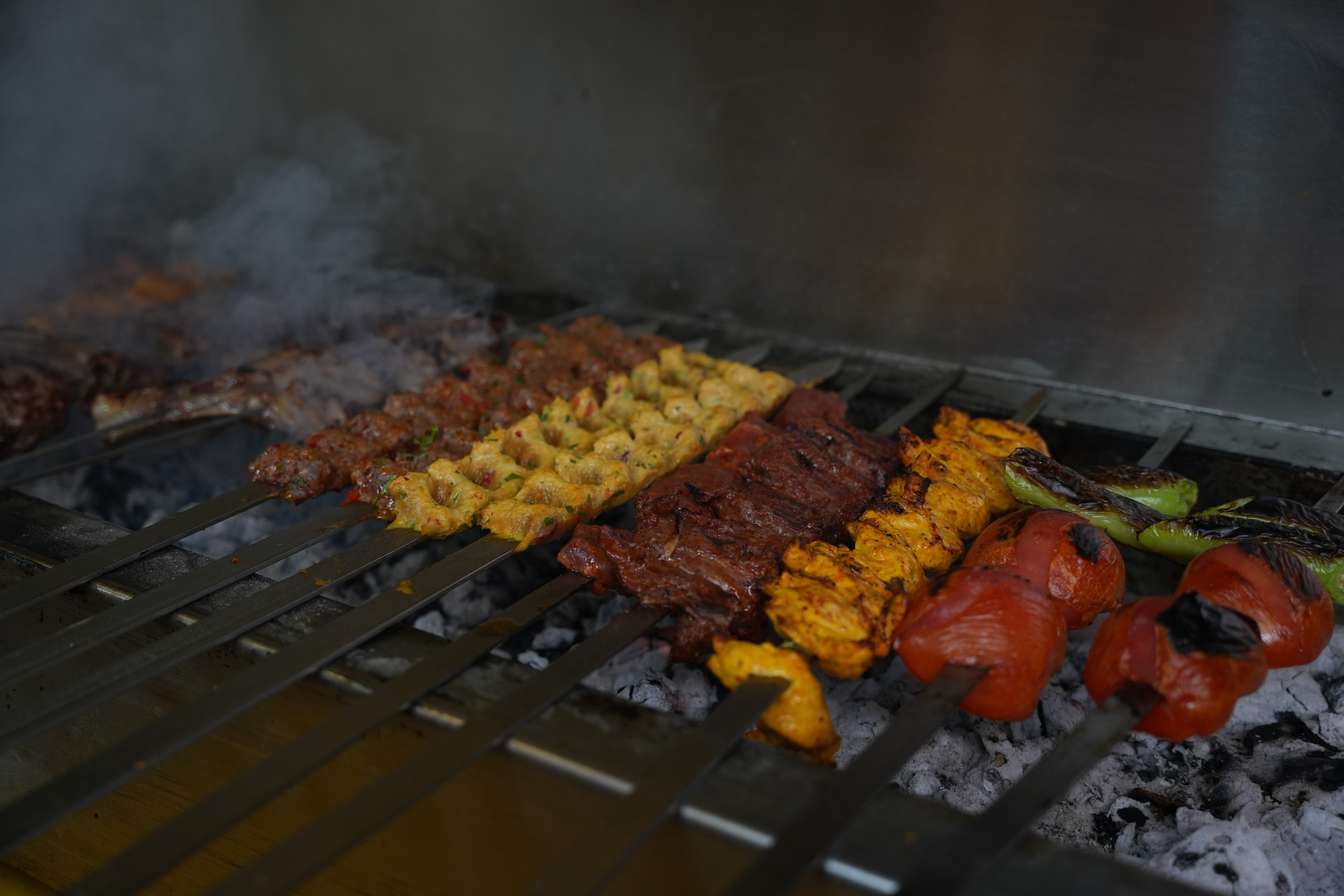 Charcoal grill with kebab skewers